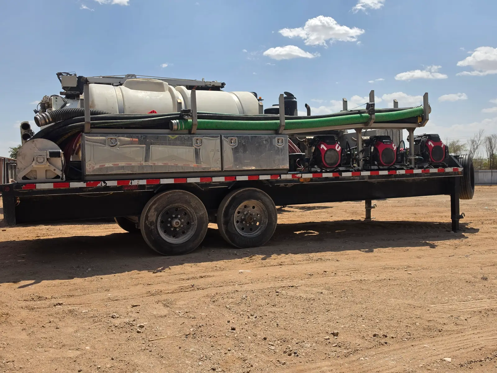 One of the Gentex wash trailers: three pressure units, hose reels, water tanks and suction hose built onto a gooseneck trailer